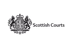 While tile with the words Scottish Courts written in black next to insignia.