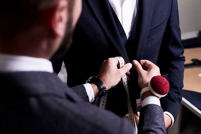 Close up of a blazer being tailored.