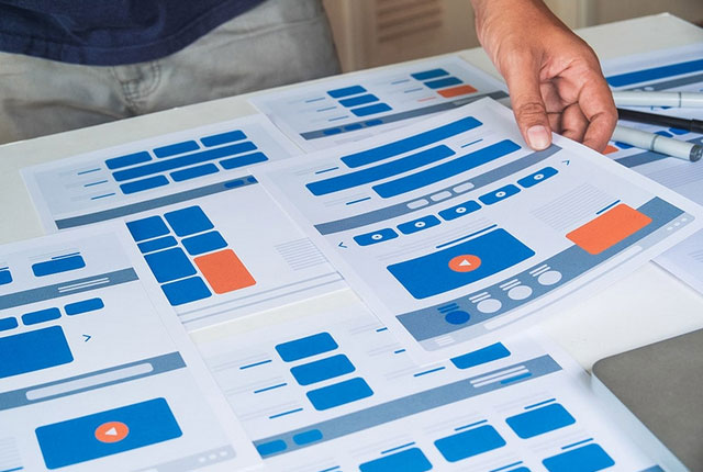 A man perusing over documents with blue and orange icons.