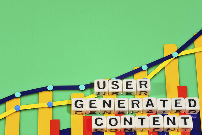A green background with a set of scrabble pieces that spell the phrase 'User Generated Content'.